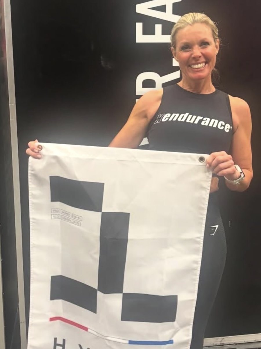 Emma Reeve holding the first-place flag, pro women 50 to 54