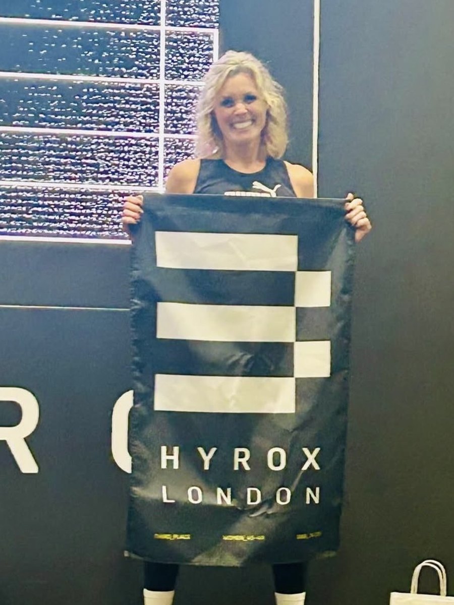 Emma Reeve holding the third-place flag at Hyrox London