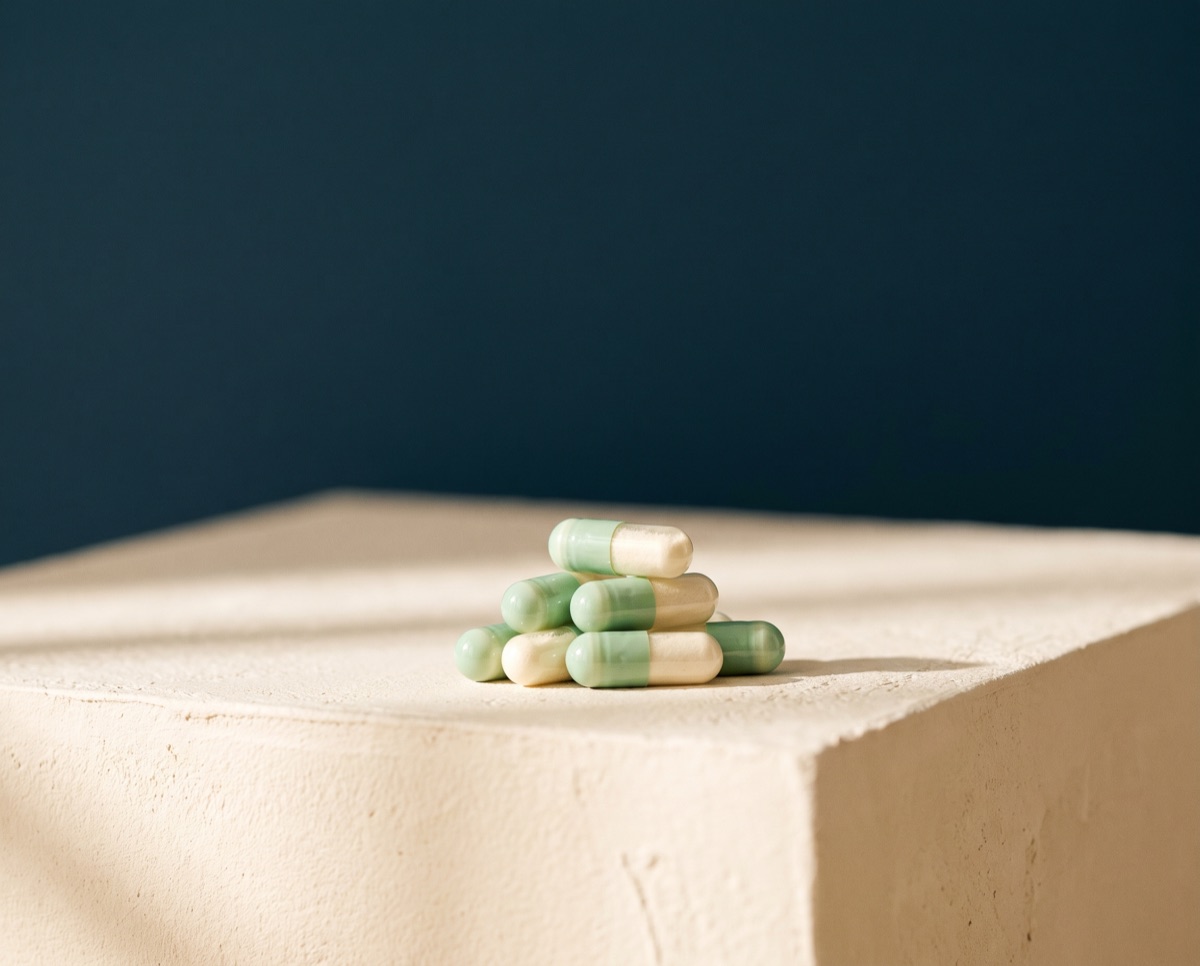Pale green and ivory probiotic capsules